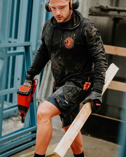 Black coloured Hard Yakka Mens Heritage Icon Lightweight Hoodie on outdoor background 