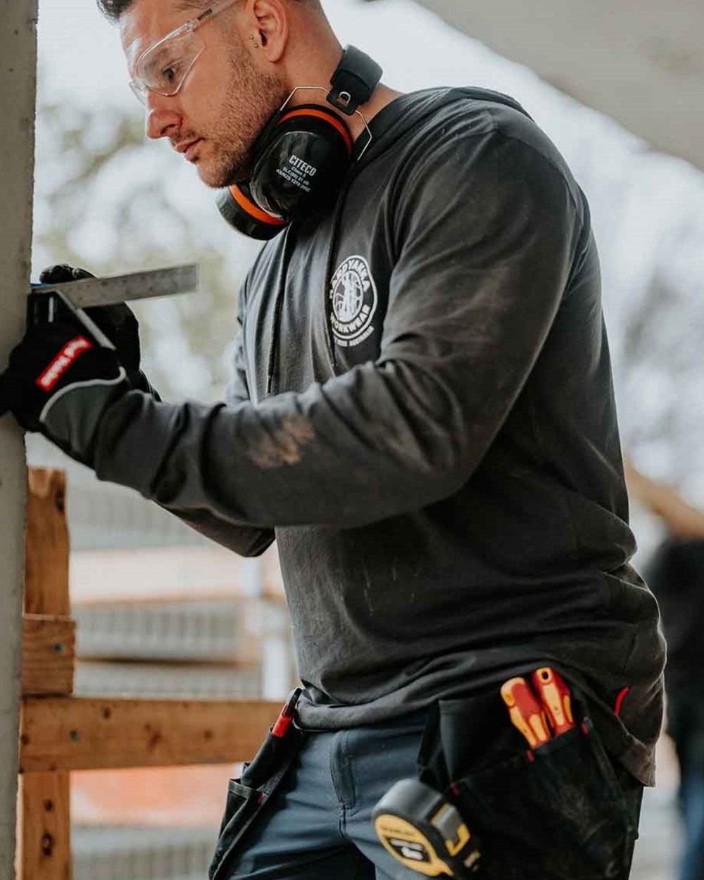 Charcoal coloured Hard Yakka Mens Heritage Icon Lightweight Hoodie on outdoor background 