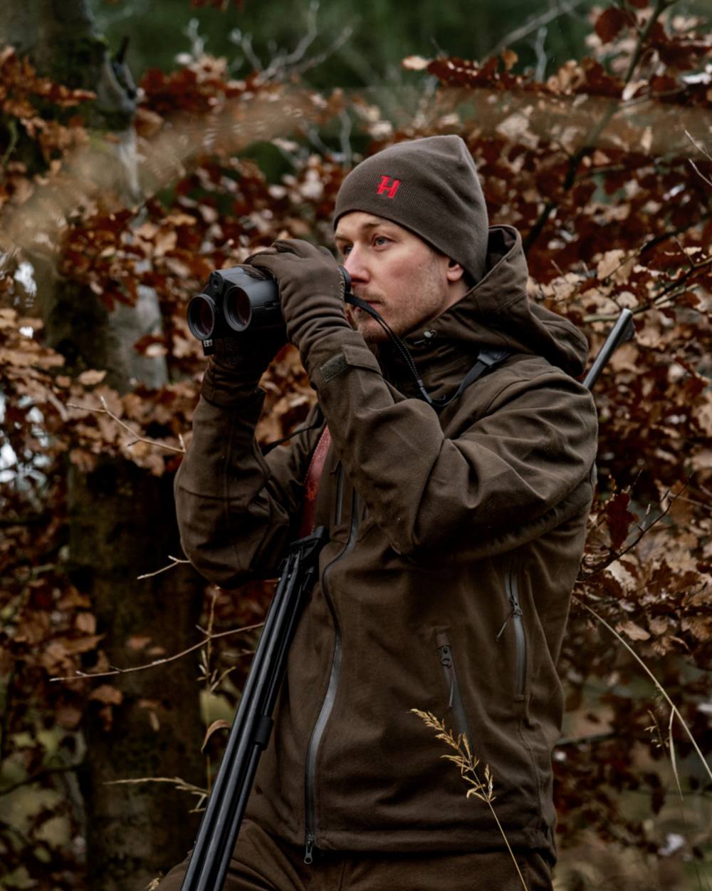 Shadow Brown Red Coloured Harkila Aspire Reversible Beanie on outdoor background 