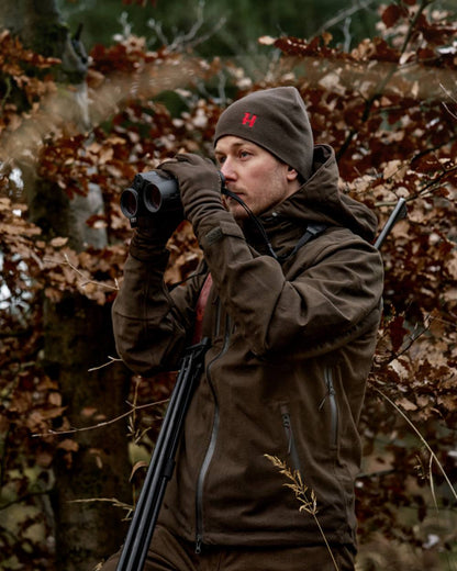 Shadow Brown Red Coloured Harkila Aspire Reversible Beanie on outdoor background 