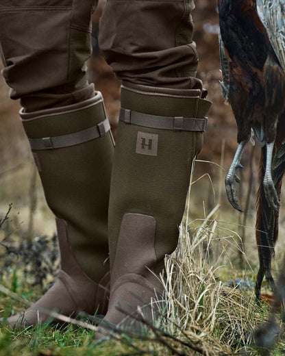 Willow Green Deep Brown Coloured Harkila Forester Zip Rubber Boot on outdoor background 