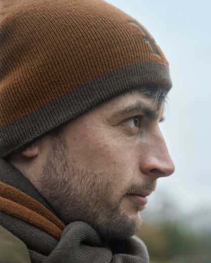 Shadow Brown Rustique Clay Coloured Harkila Reversible Beanie on outdoor background 