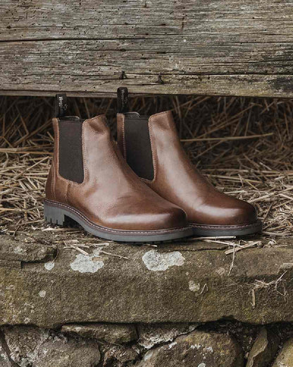 Burnished Tan Coloured Hoggs of Fife Banff Country Dealer Boots on grass background 