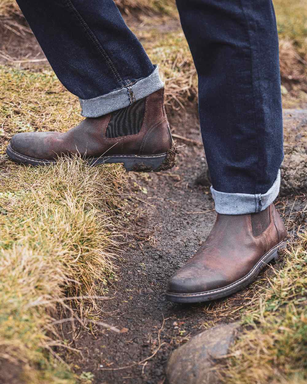 Waxy Brown Coloured Hoggs of Fife Banff Country Dealer Boots on land background 