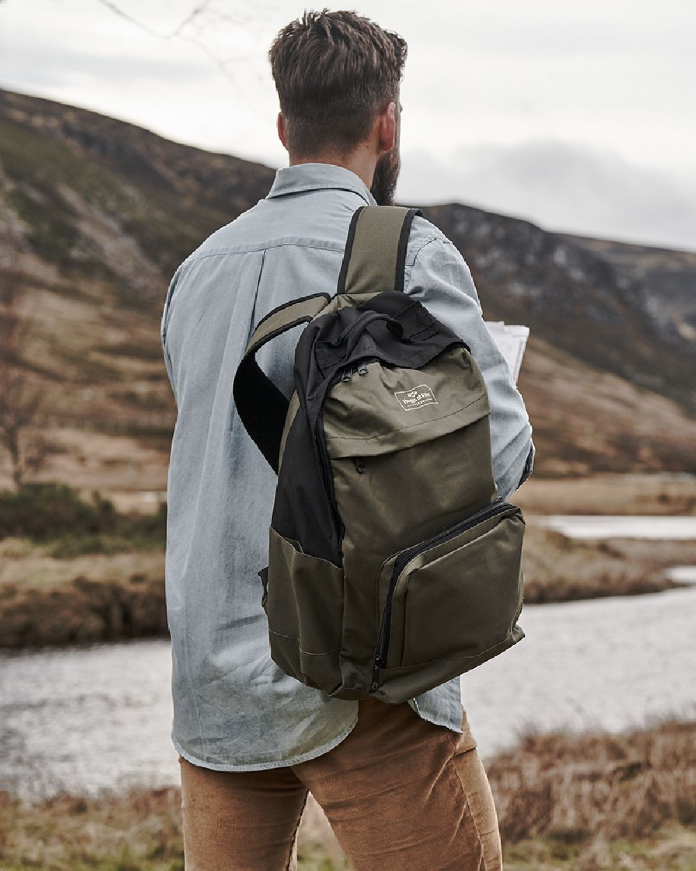 Green Black Coloured Hoggs of Fife Field & Trek Backpack on mountain background