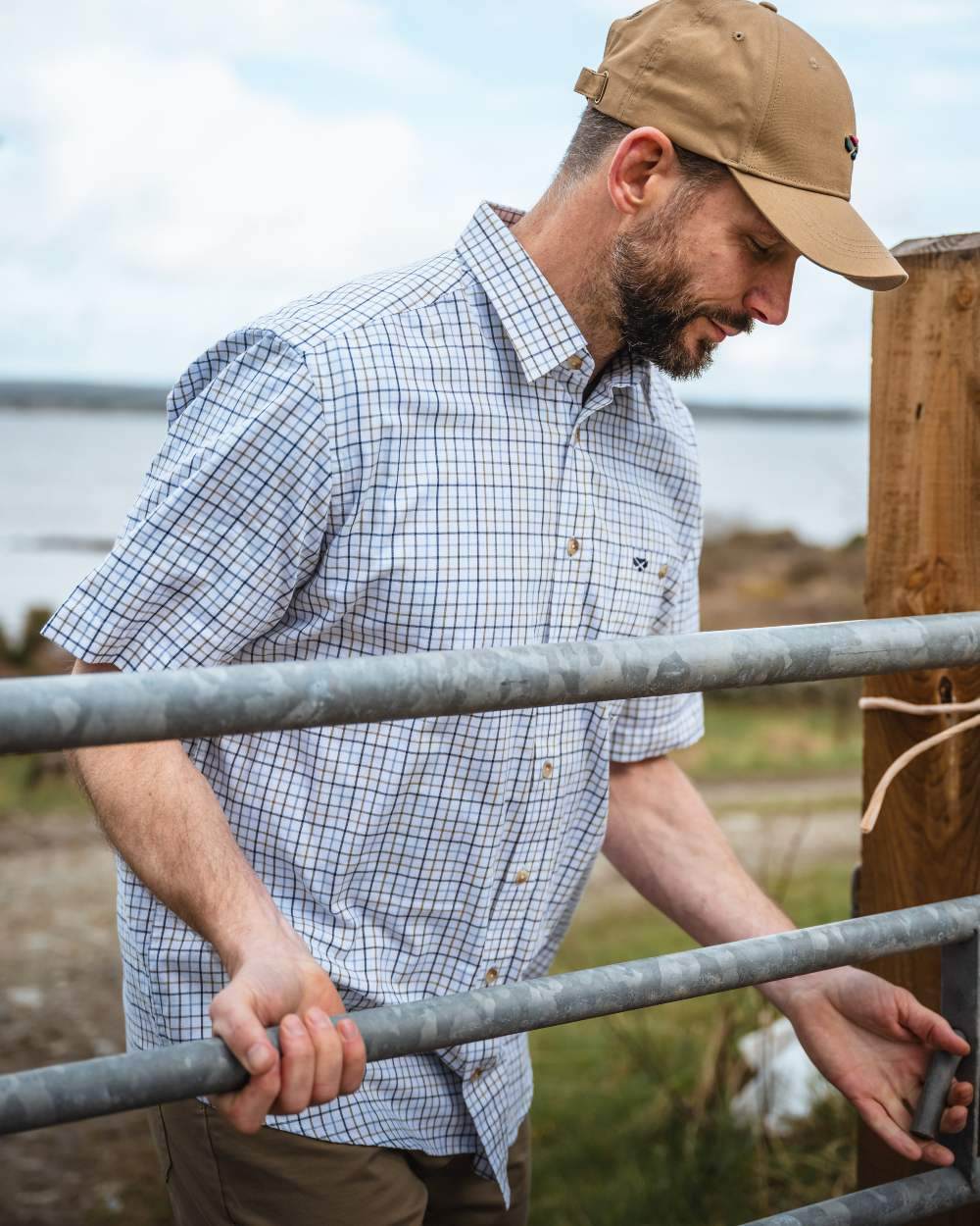 Brown Blue Coloured Hoggs of Fife Kessock Tattersall Short Sleeved Shirt on coastal background 