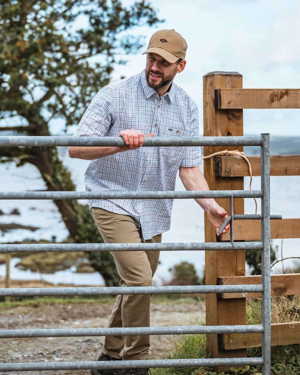 Brown Blue Coloured Hoggs of Fife Kessock Tattersall Short Sleeved Shirt on coastal background 