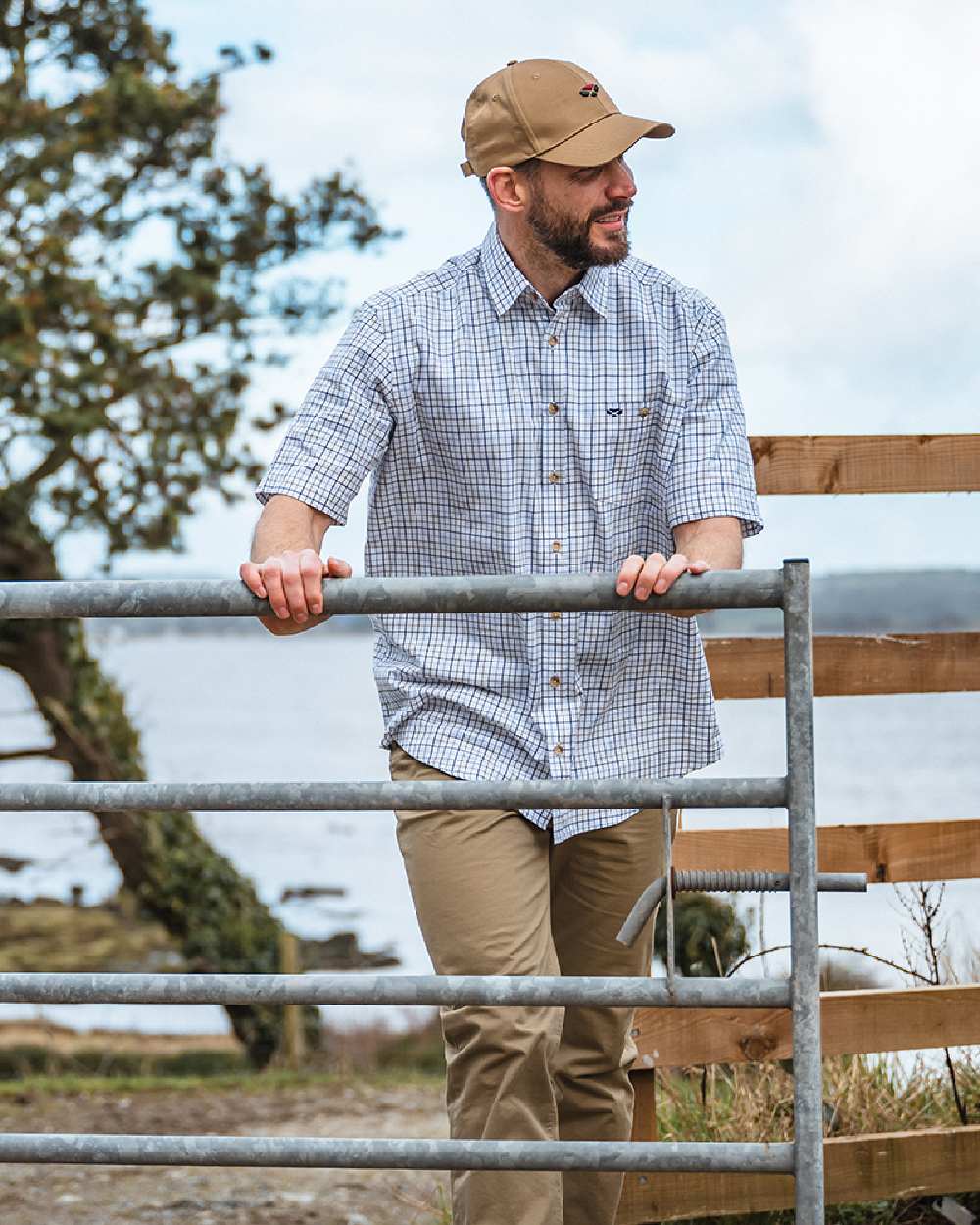 Green Red Coloured Hoggs of Fife Kessock Tattersall Short Sleeved Shirt on coastal background 