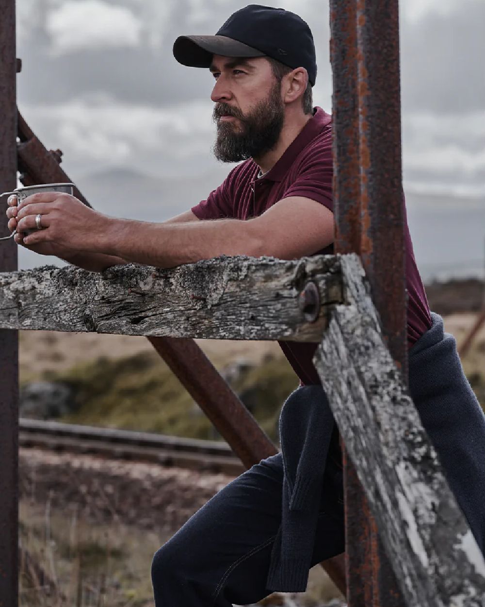 Bordeaux Coloured Hoggs of Fife Largs Pique Polo Shirt on countryside background 