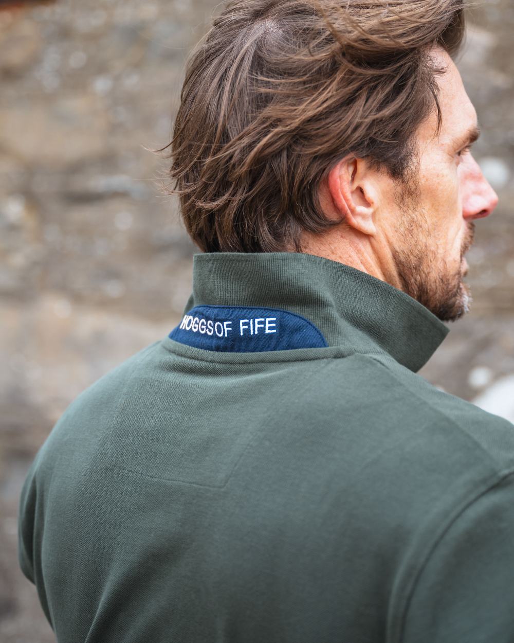 Forest Coloured Hoggs of Fife Mens Newton Pique Polo Shirt on blurry background 