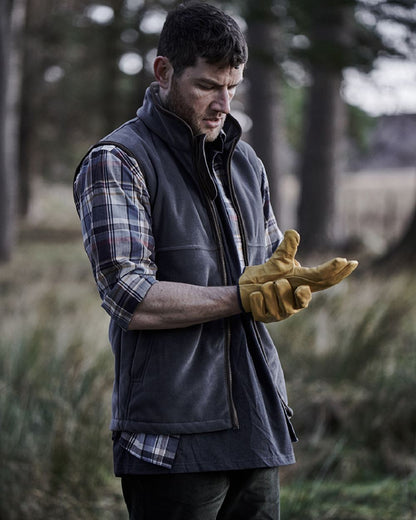 Slate Grey coloured Hoggs of Fife Stenton Technical Fleece Gilet on forest background 