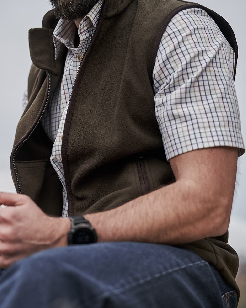 Green Coloured Hoggs of Fife Woodhall Fleece Gilet on blurry background
