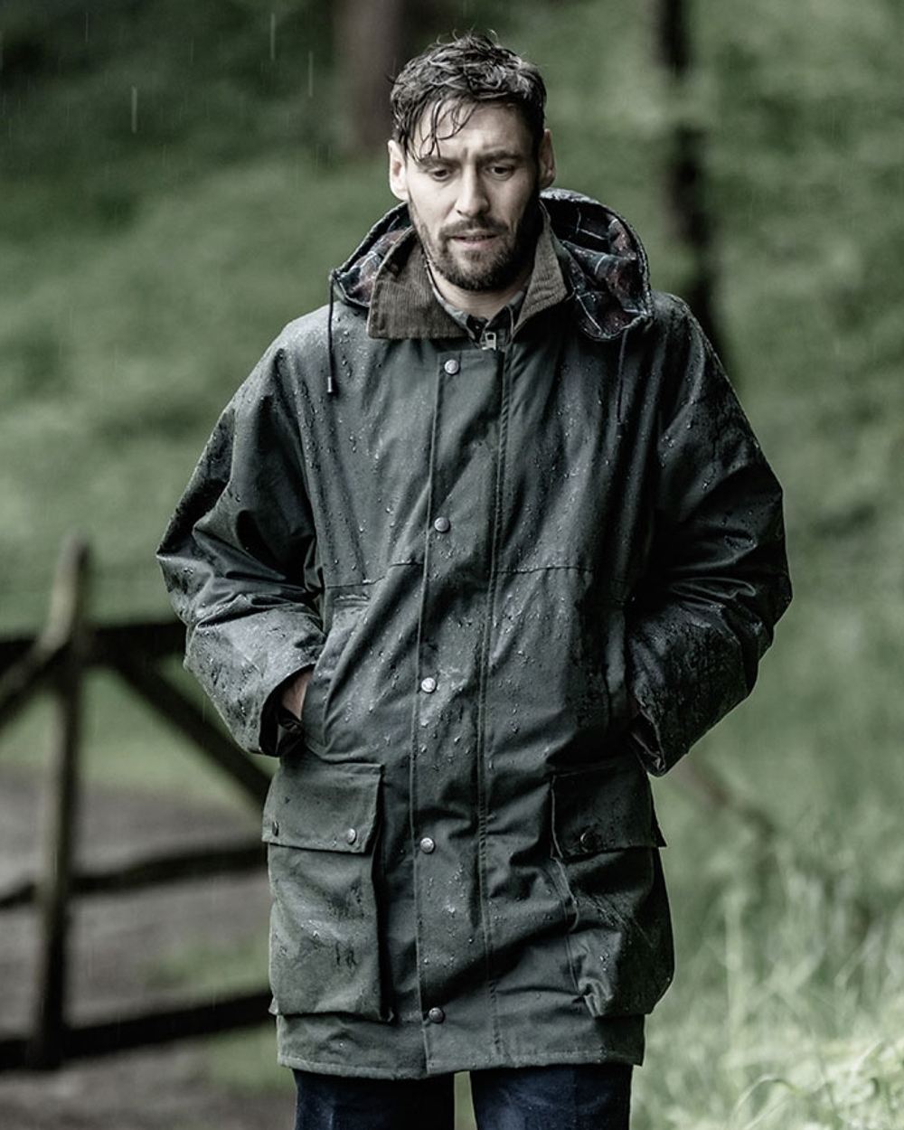 Olive Coloured Hoggs of Fife Woodsman Waxed Jacket on forest background 