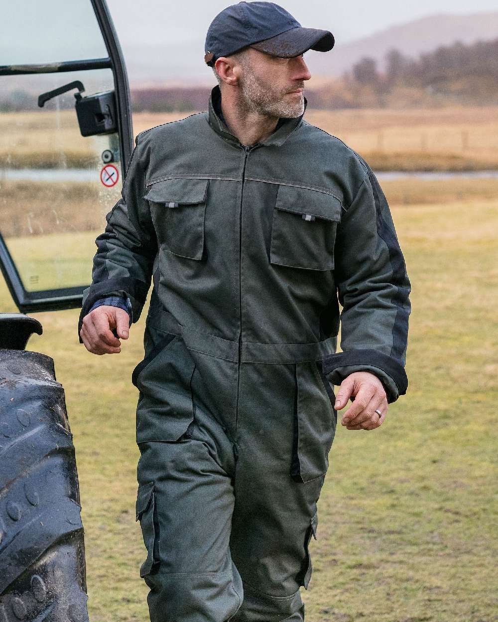 Spruce Black Coloured Hoggs of Fife Workhogg Zipped Cotton Coverall on countryside background 