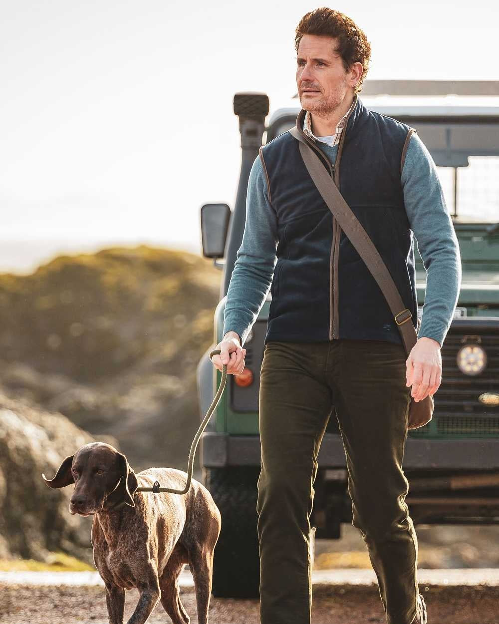 Midnight Navy coloured Hoggs of Fife Stenton Technical Fleece Gilet on blurry mountain background 