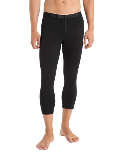 Black coloured Icebreaker Mens Merino 200 Oasis Mid Calf Thermal Leggings on white background 