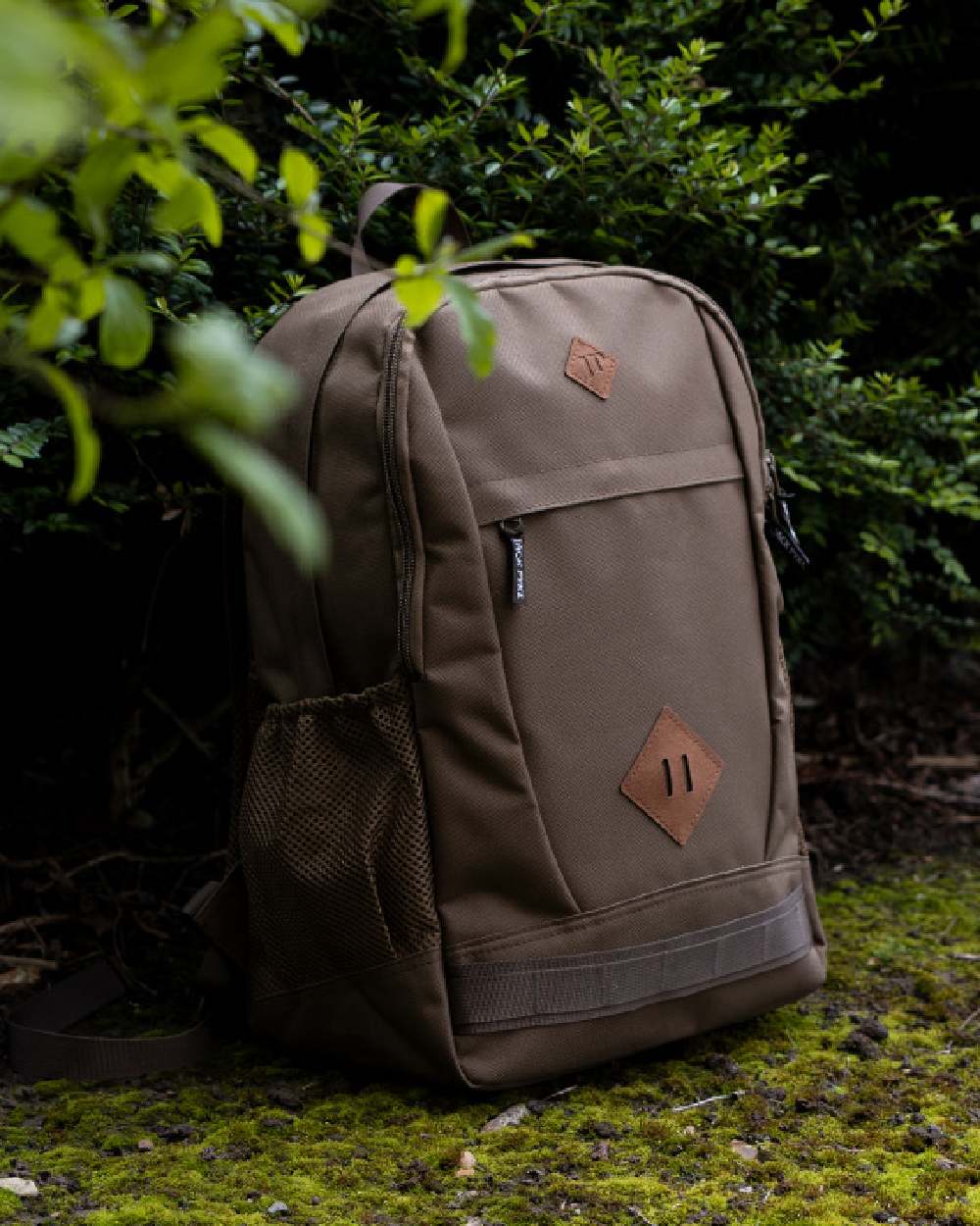 Olive Brown coloured Jack Pyke Falcon Rucksack on leafy background 