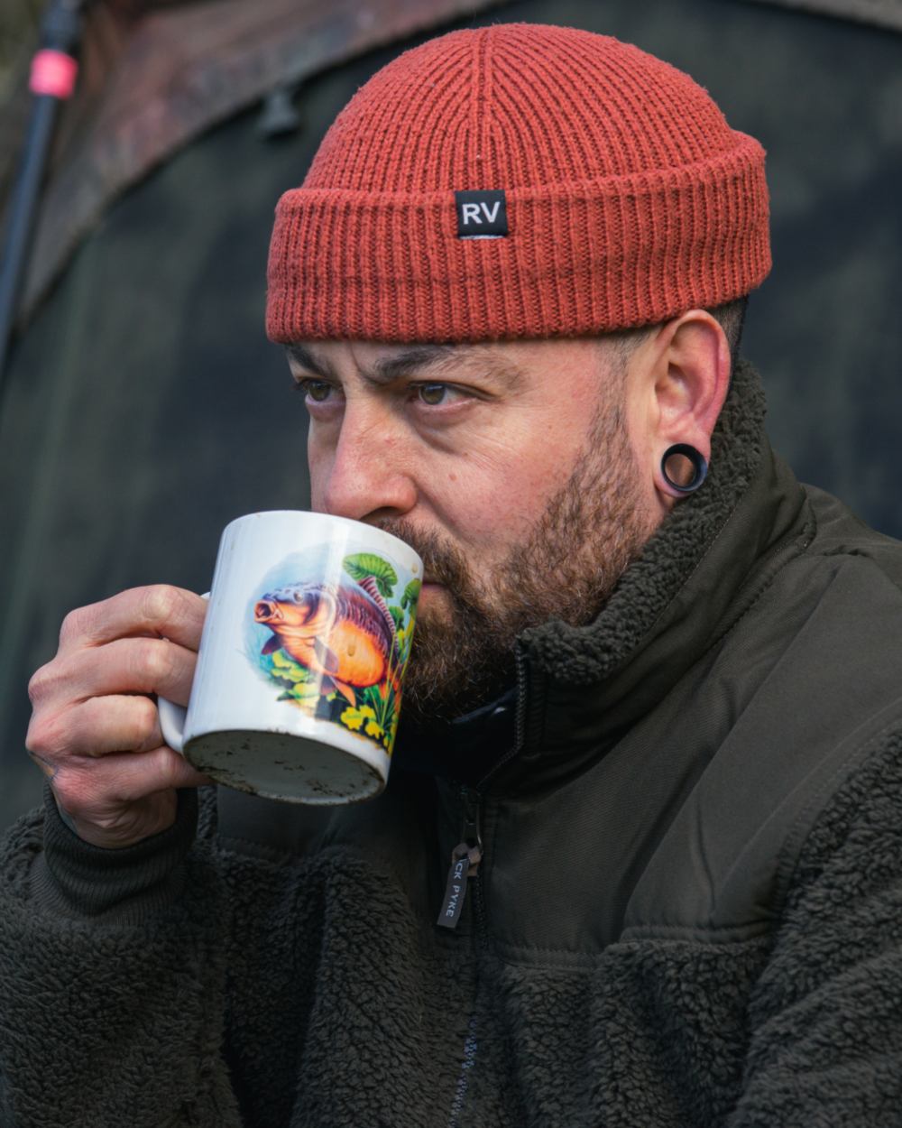 Dark Olive coloured Jack Pyke Sherpa Fleece Jacket Gen 2 on forest background 