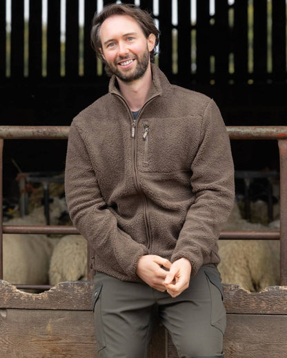 Green coloured Jack Pyke Shires Fleece Jacket on yard background 