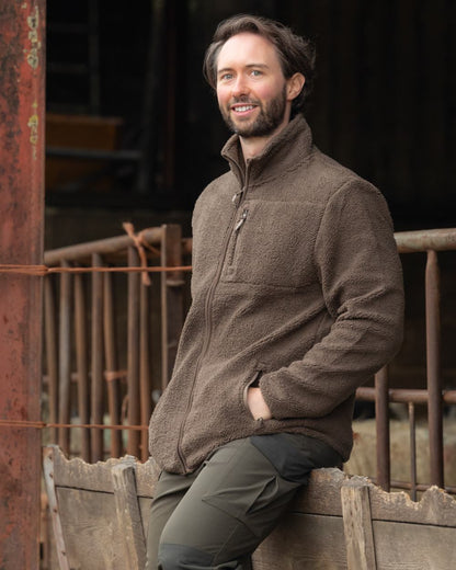 Green coloured Jack Pyke Shires Fleece Jacket on yard background 