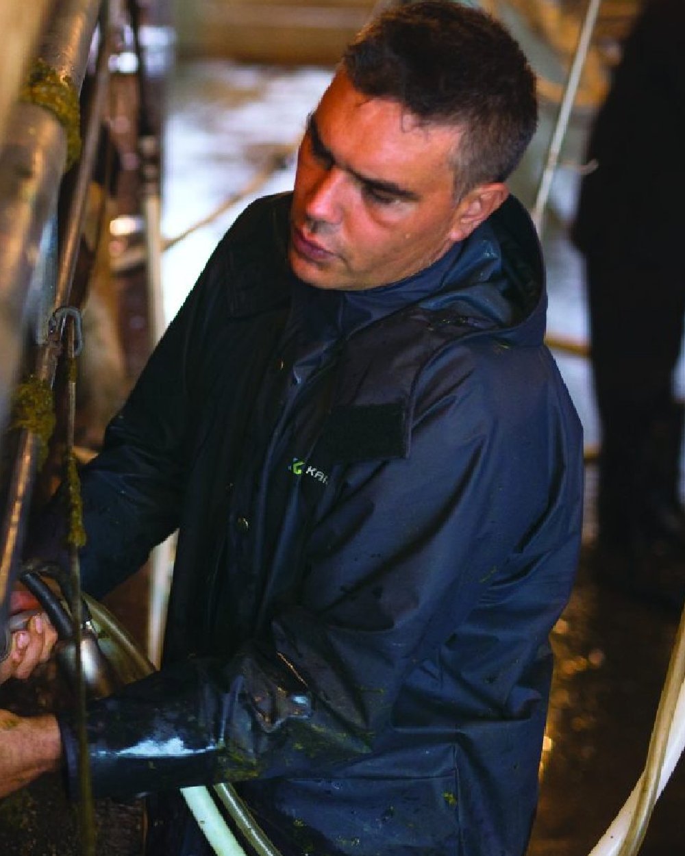 Navy coloured Kaiwaka Mens AgTex Parka on factory background 