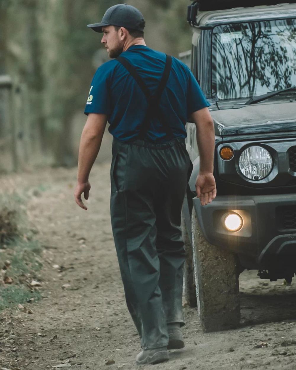 Green coloured Kaiwaka Mens Dairytex Bib Overtrousers on forest background 