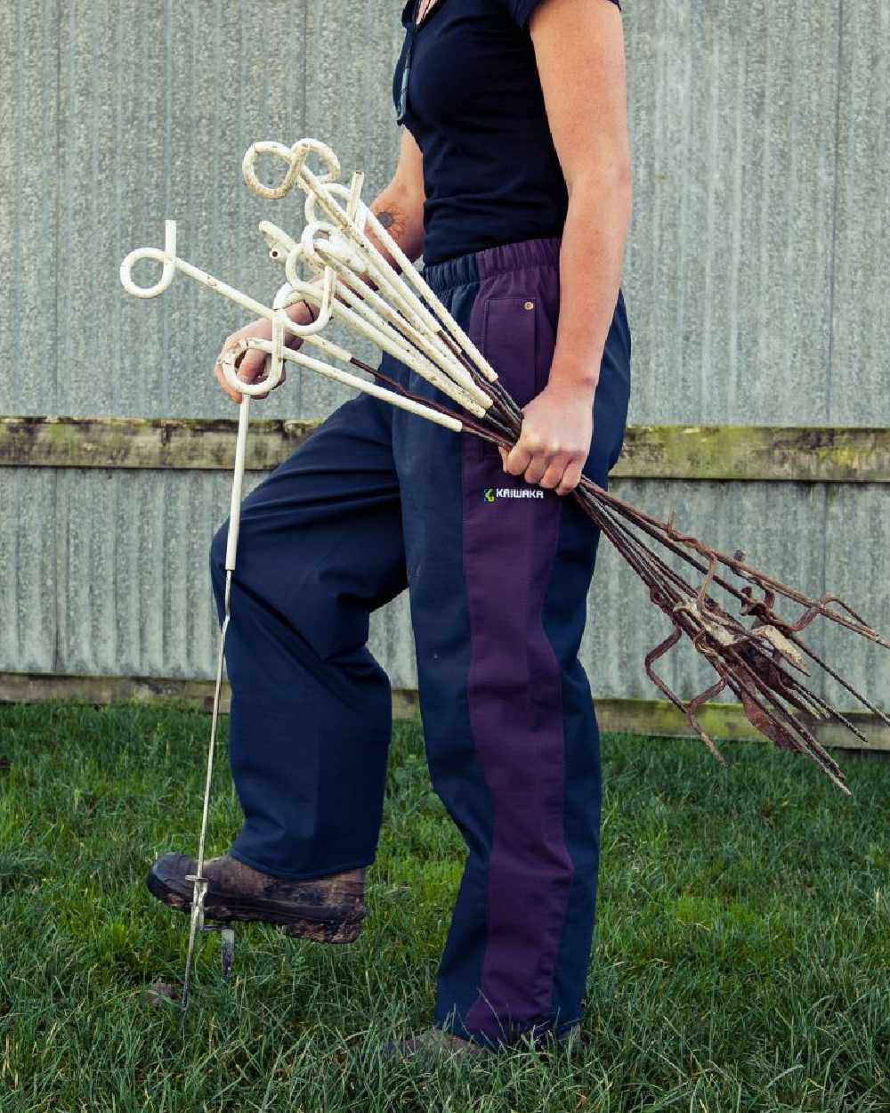 Navy coloured Kaiwaka Womens Stormforce Overtrouser on grassy background 