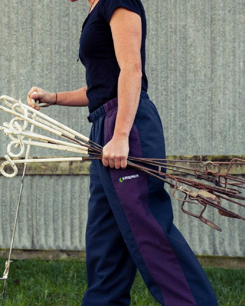 Navy coloured Kaiwaka Womens Stormforce Overtrouser on grassy background 