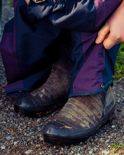 Navy coloured Kaiwaka Womens Stormforce Overtrouser on soil background 