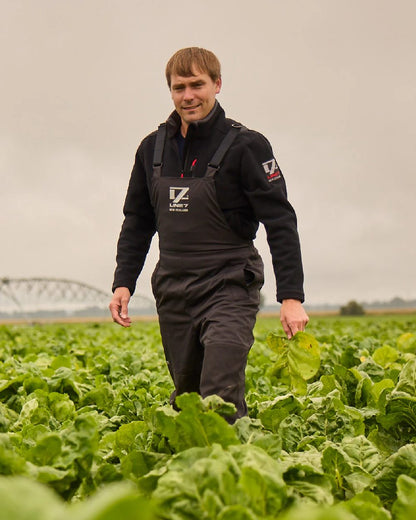 Black Coloured Line 7 Mens Storm Pro 20 Bib Pant V2 on farm background 