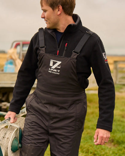 Black Coloured Line 7 Mens Storm Pro 20 Bib Pant V2 on farm background 