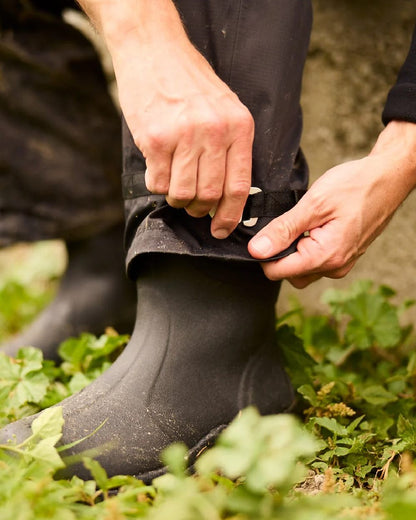 Black coloured Line 7 Mens Territory Storm Pro20 Waterproof Overtrouser on farm background 