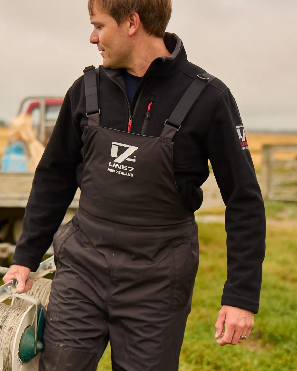 Black Coloured Line 7 Mens Territory Wind Pro Half Zip Fleece Jacket on farm background 