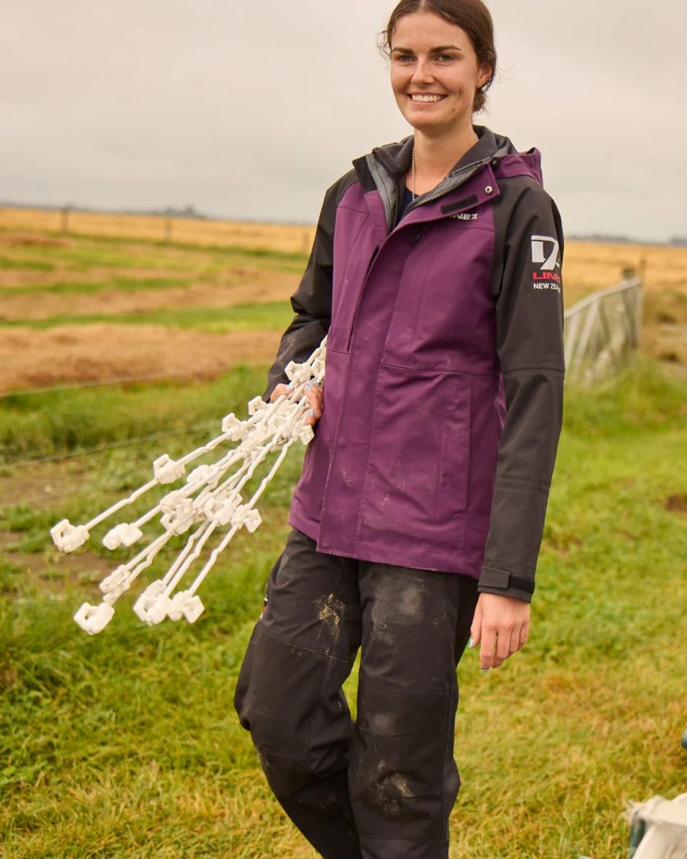 Black coloured Line 7 Womens Territory Storm Pro20 Waterproof Overtrouser on farm background 