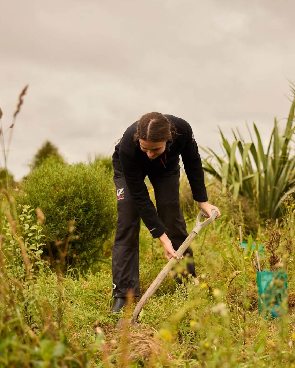 Black coloured Line 7 Womens Territory Storm Pro20 Waterproof Overtrouser on farm background 