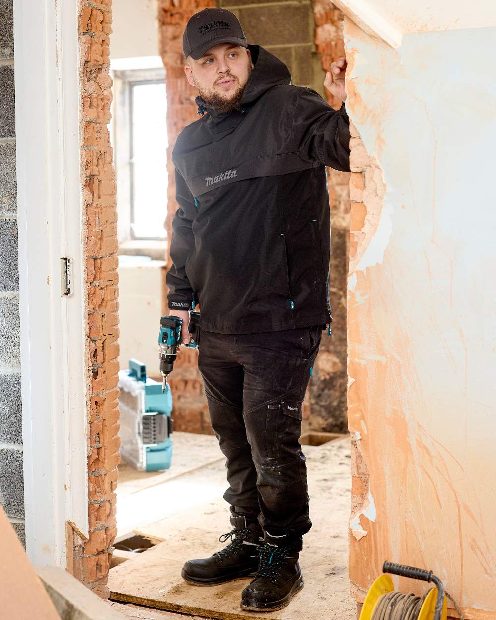 Black Coloured Makita Mens Axis Stretch Joggers on indoor background 