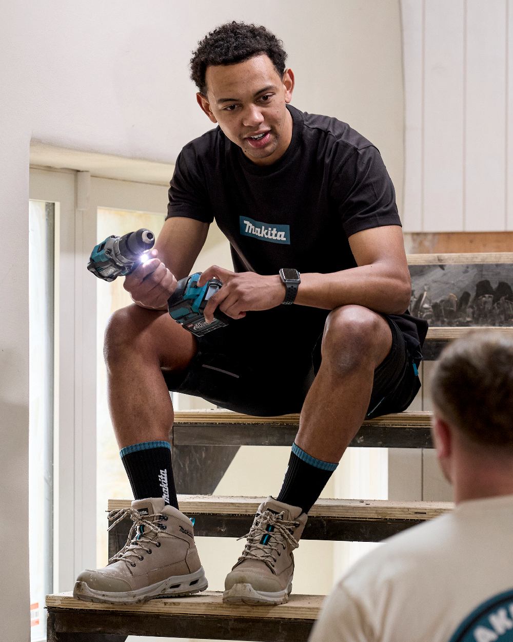 Black Coloured Makita Mens Origin T-Shirt on construction background 