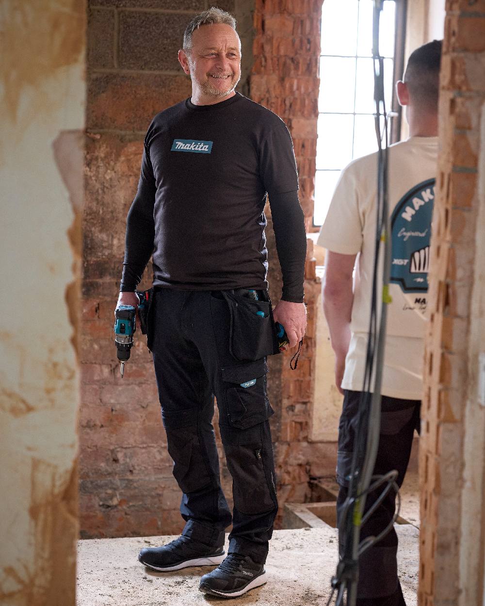 Black Coloured Makita Mens Origin T-Shirt on construction background 