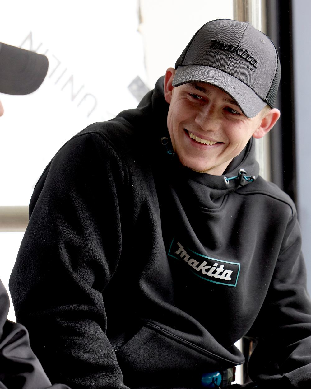 Grey Coloured Makita Mens Origin Trucker Cap on outdoor background 