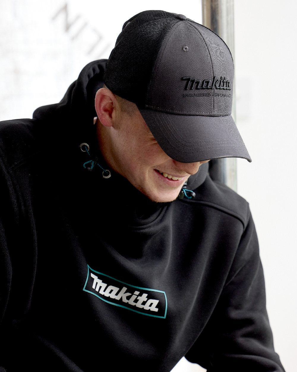 Grey Coloured Makita Mens Origin Trucker Cap on outdoor background 