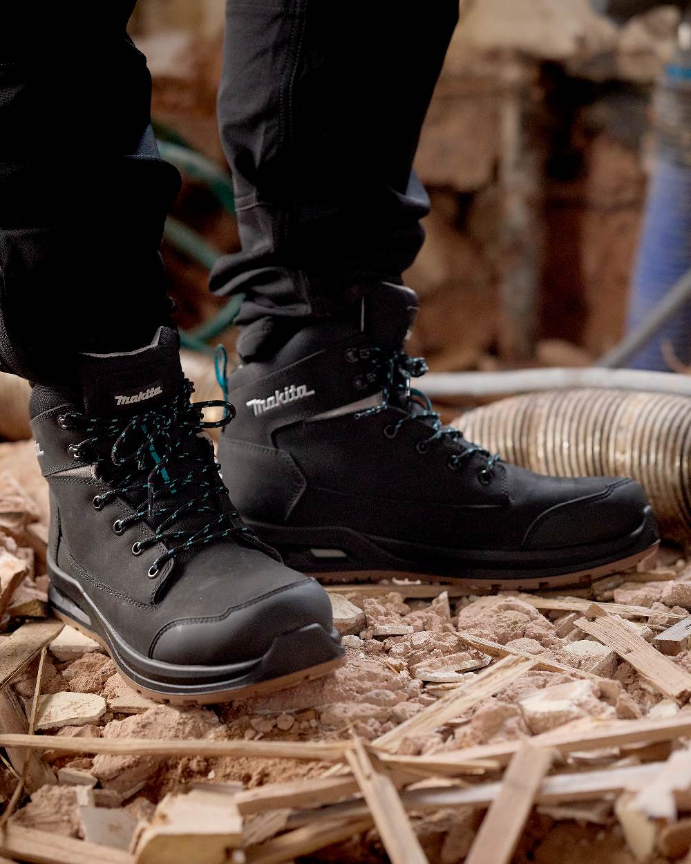 Black Coloured Makita Mens Osaka Safety Boots on construction background 