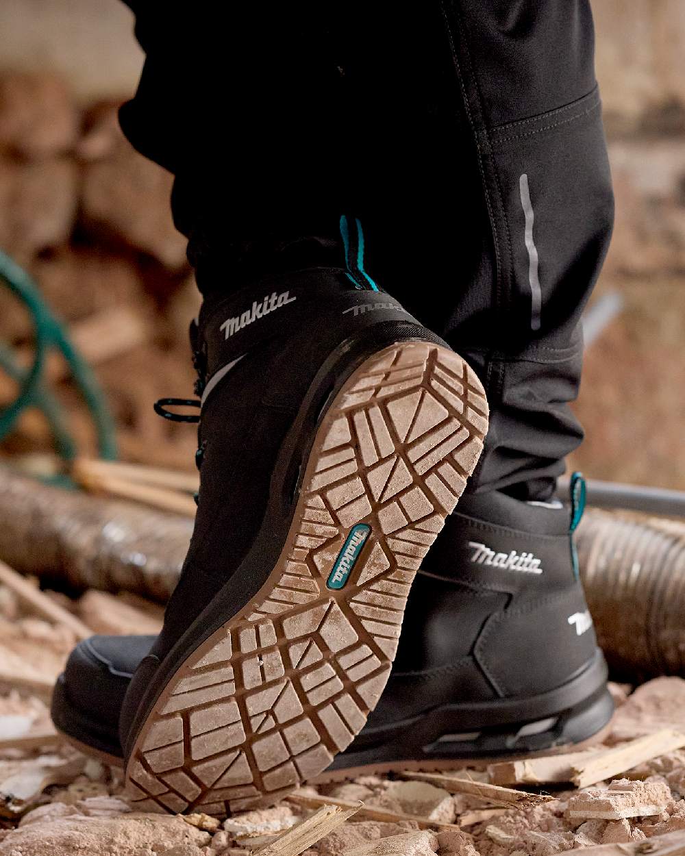 Black Coloured Makita Mens Osaka Safety Boots on construction background 