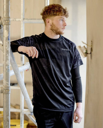Black Coloured Makita Mens Tech T-Shirt on construction background 