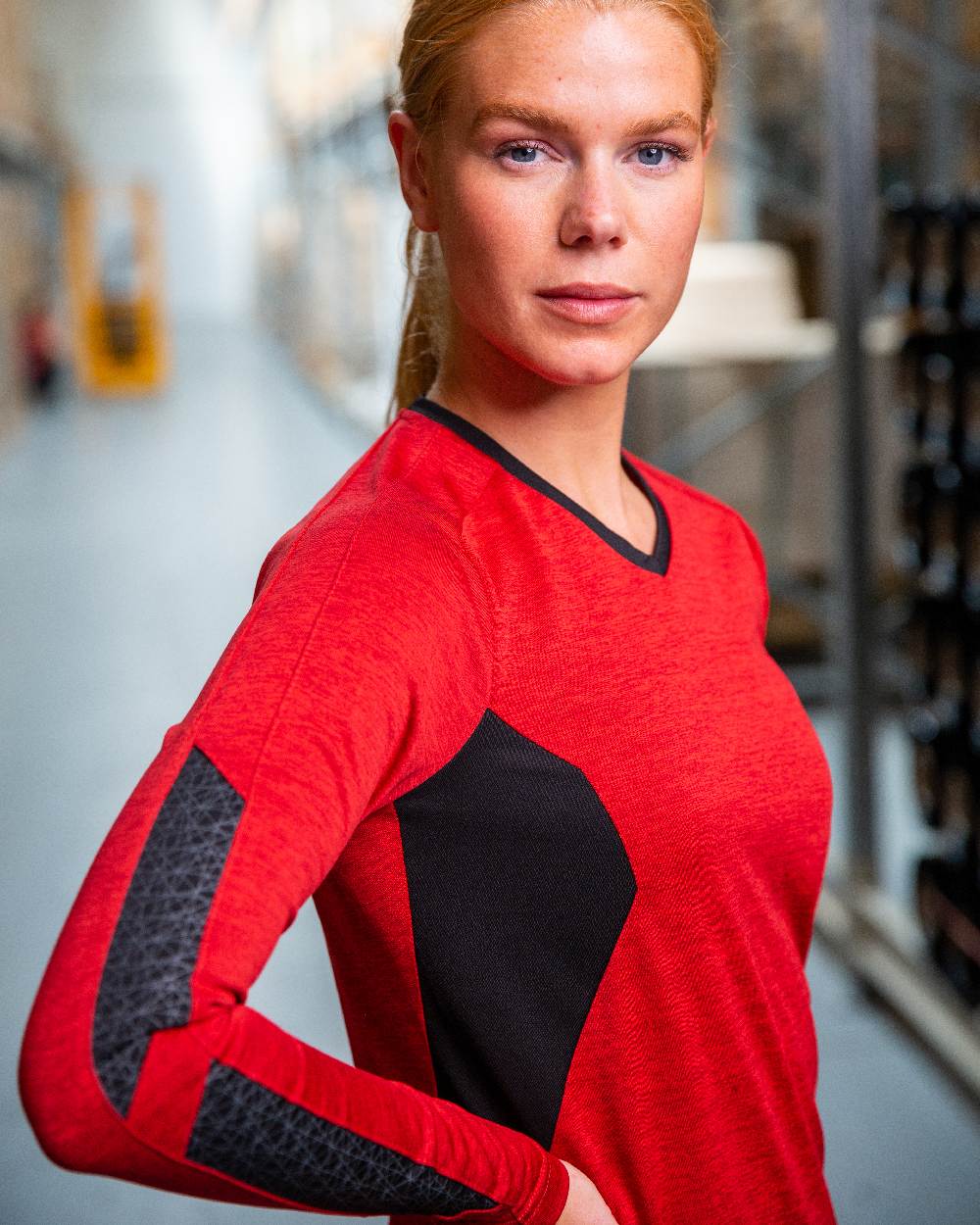 Traffic Red Black Coloured Mascot Womens Accelerate V-Neck Long Sleeved T-Shirt on factory background 
