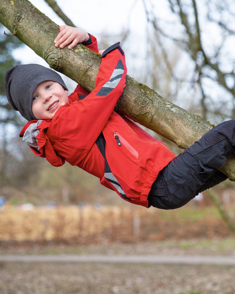 Traffic Red Black Coloured Mascot Workwear Childrens Accelerate Lightweight Outer Shell Jacket on outdoor background 