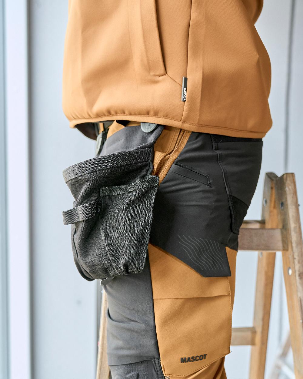 Black Coloured Mascot Workwear Customized Click Pocket System Holster Pocket on construction background 