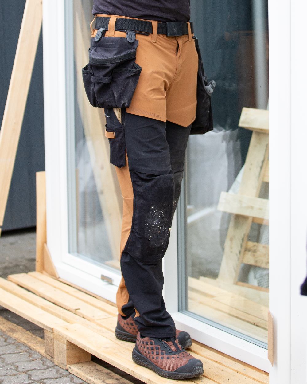 Black Coloured Mascot Workwear Customized Click Pocket System Holster Pocket on construction background 