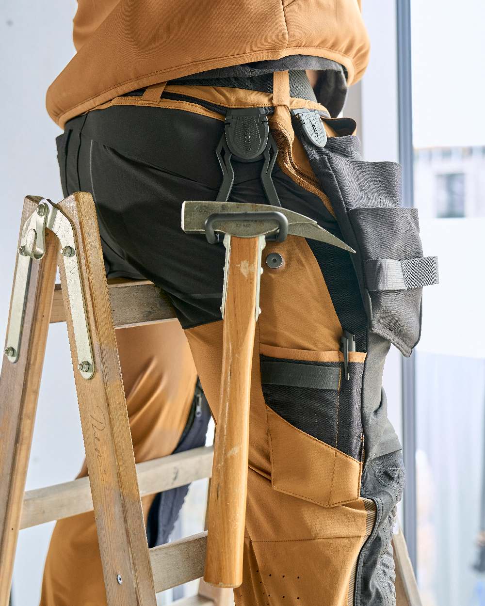 Black Coloured Mascot Workwear Customized Click System Foldable Hammer Holder on construction background 