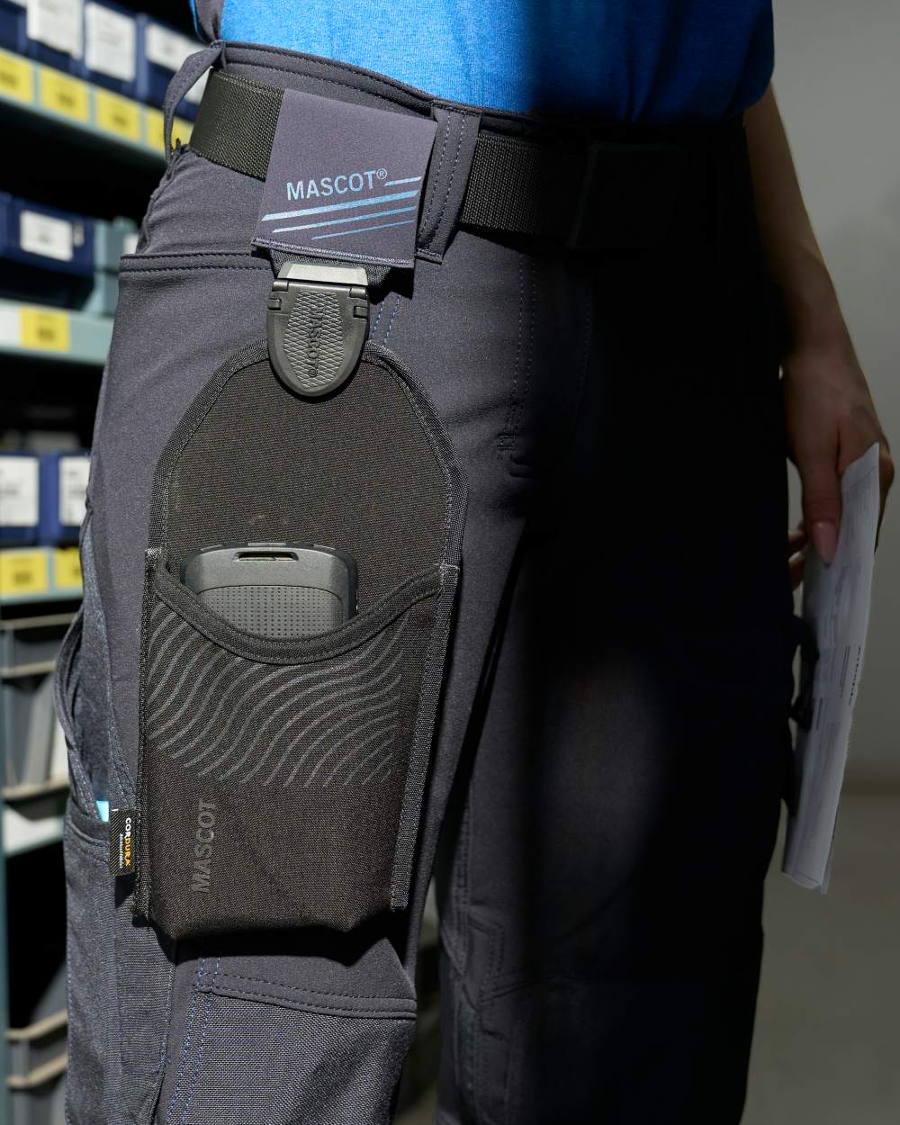 Black Coloured Mascot Workwear Customized Click System Holster Pocket on warehouse background 