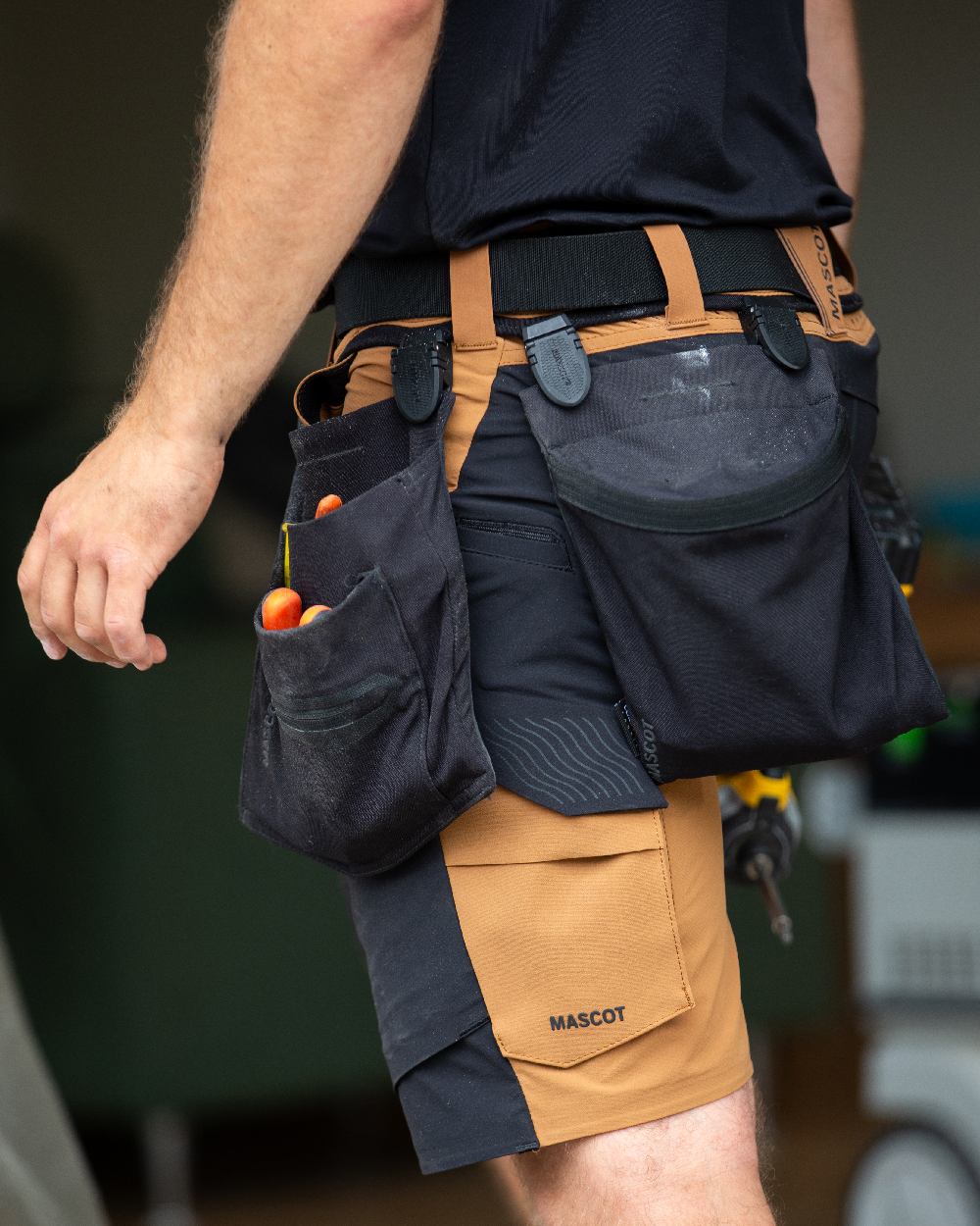 Black Coloured Mascot Workwear Customized Click System Magnet Closure Holster Pocket on construction background 